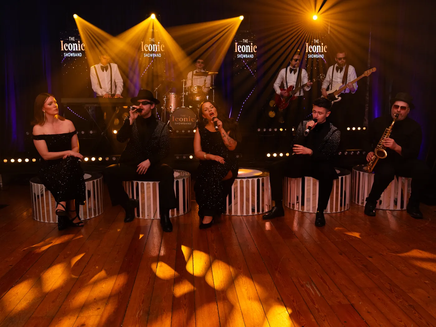 The band performing a seated acoustic set