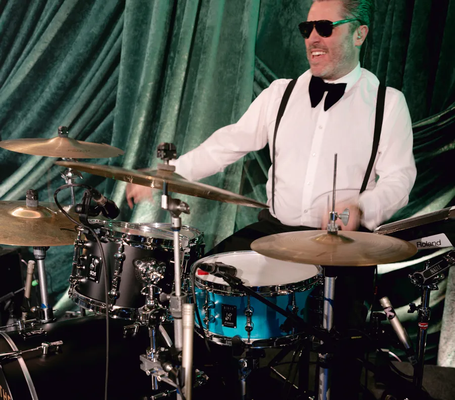 Drummer smiling behind the kit
