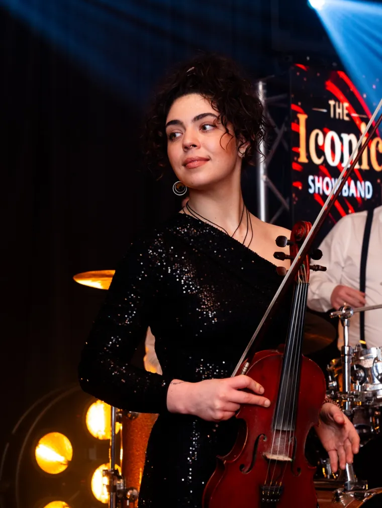 Violinist performing with the band