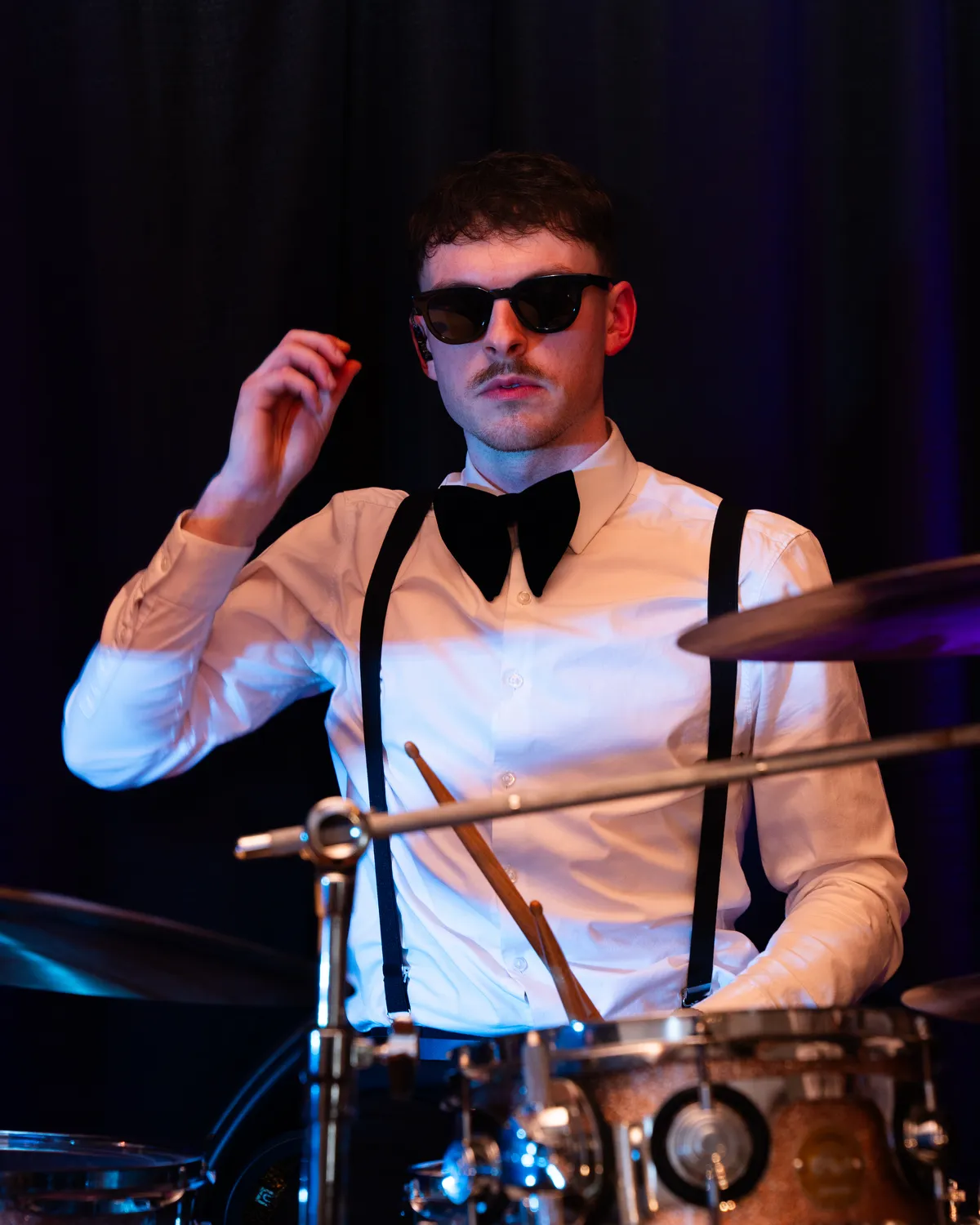 Drummer performing with the band